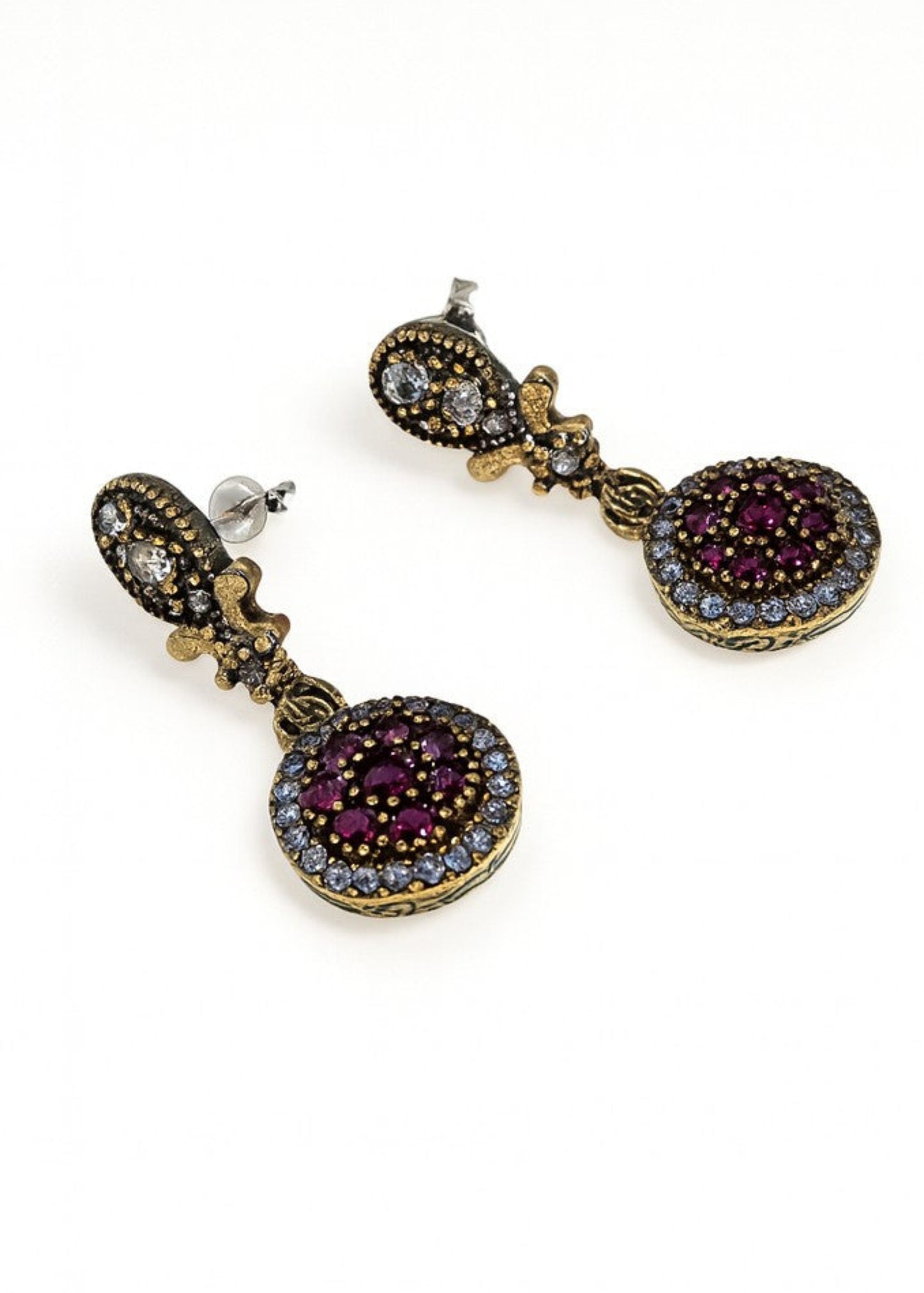 Pair of gold earrings with gemstones on a white background