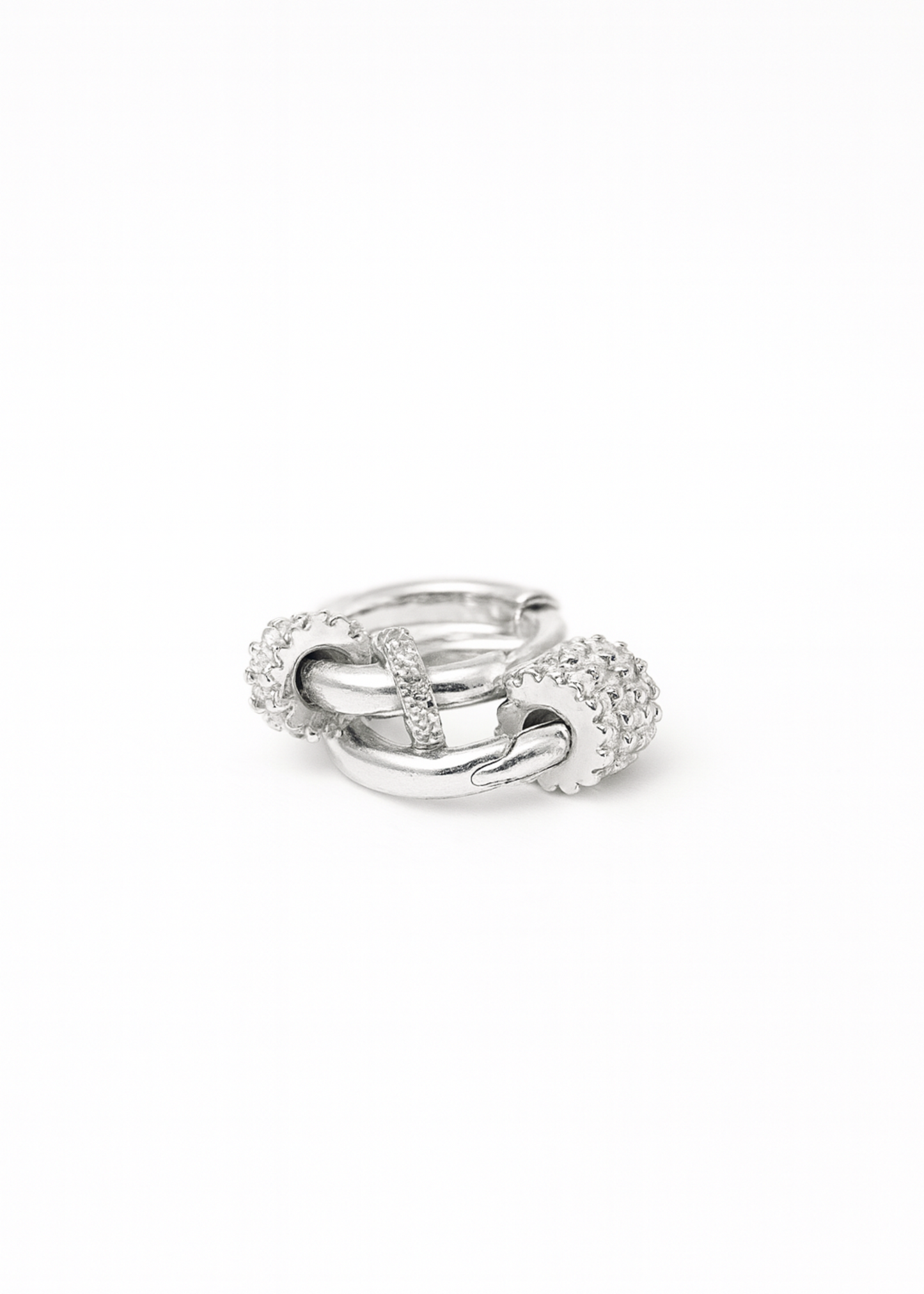 Silver ring with interlocking design on a white background