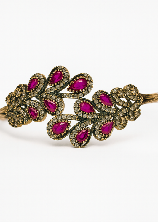 Bracelet with pink gemstones and bronze accents on a white background