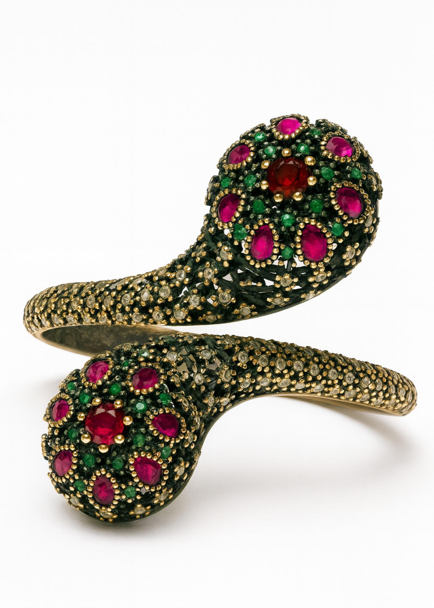 Gold bracelet with red and green gemstones on a white background