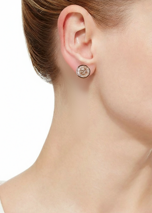 Close-up of a diamond earring on an ear with a neutral background