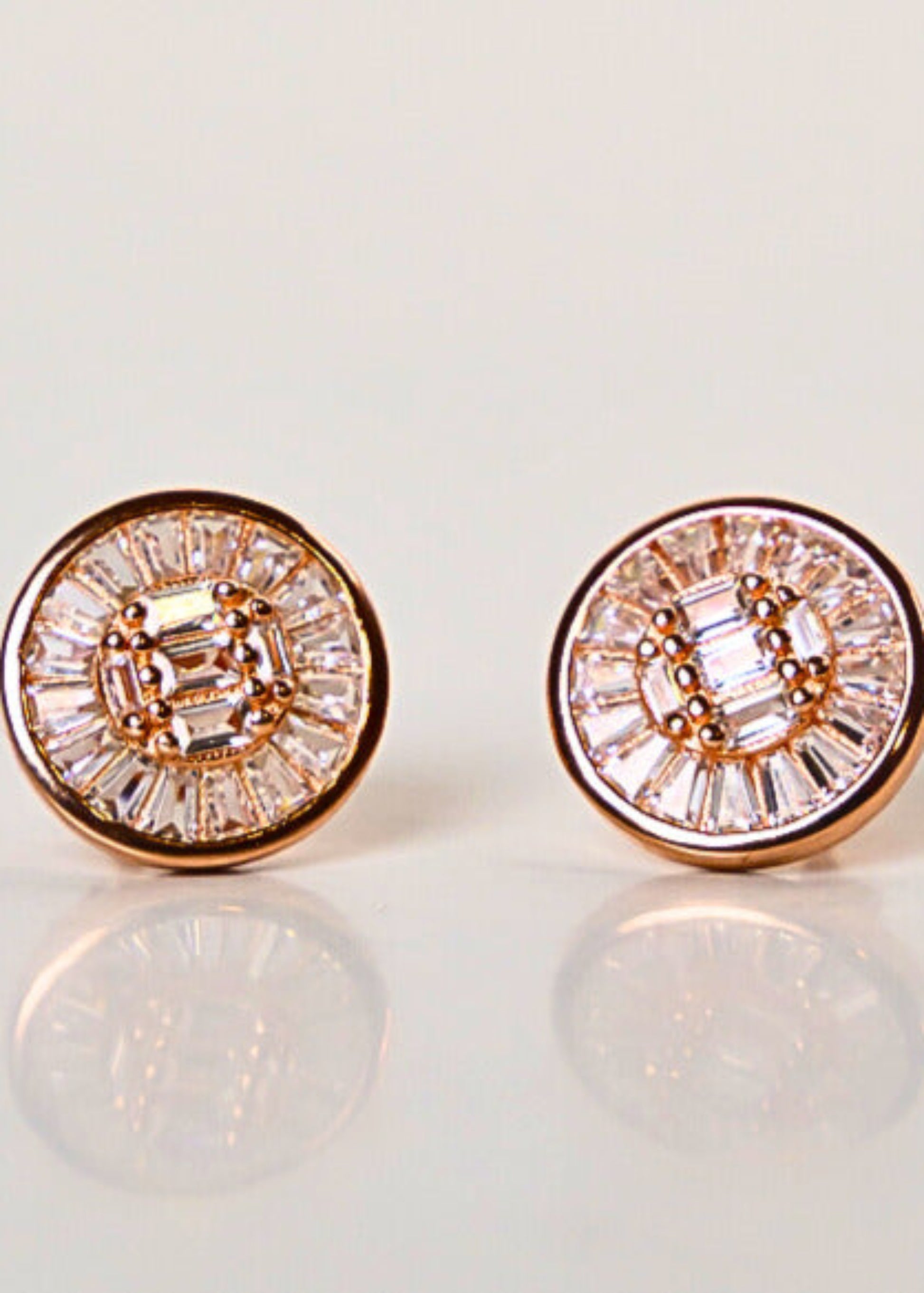 Pair of diamond stud earrings on a light background