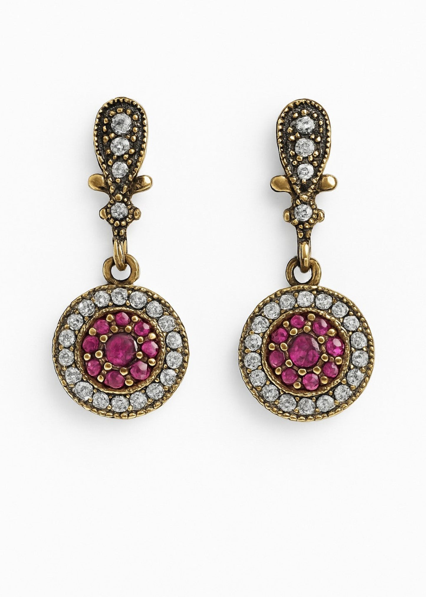 Pair of gold earrings with pink gemstones and diamond-like stones on a white background
