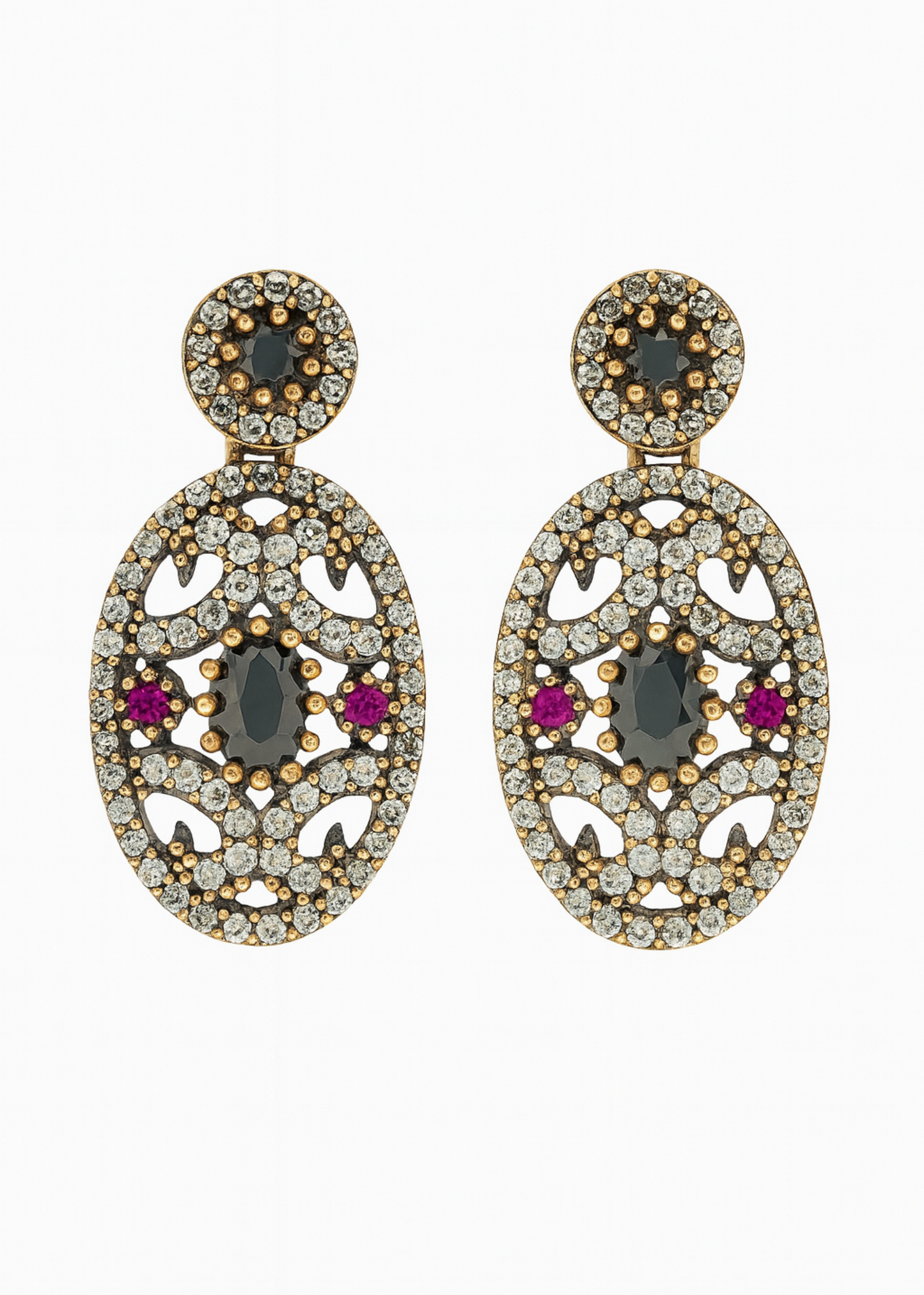 Pair of ornate earrings with gemstones on a white background