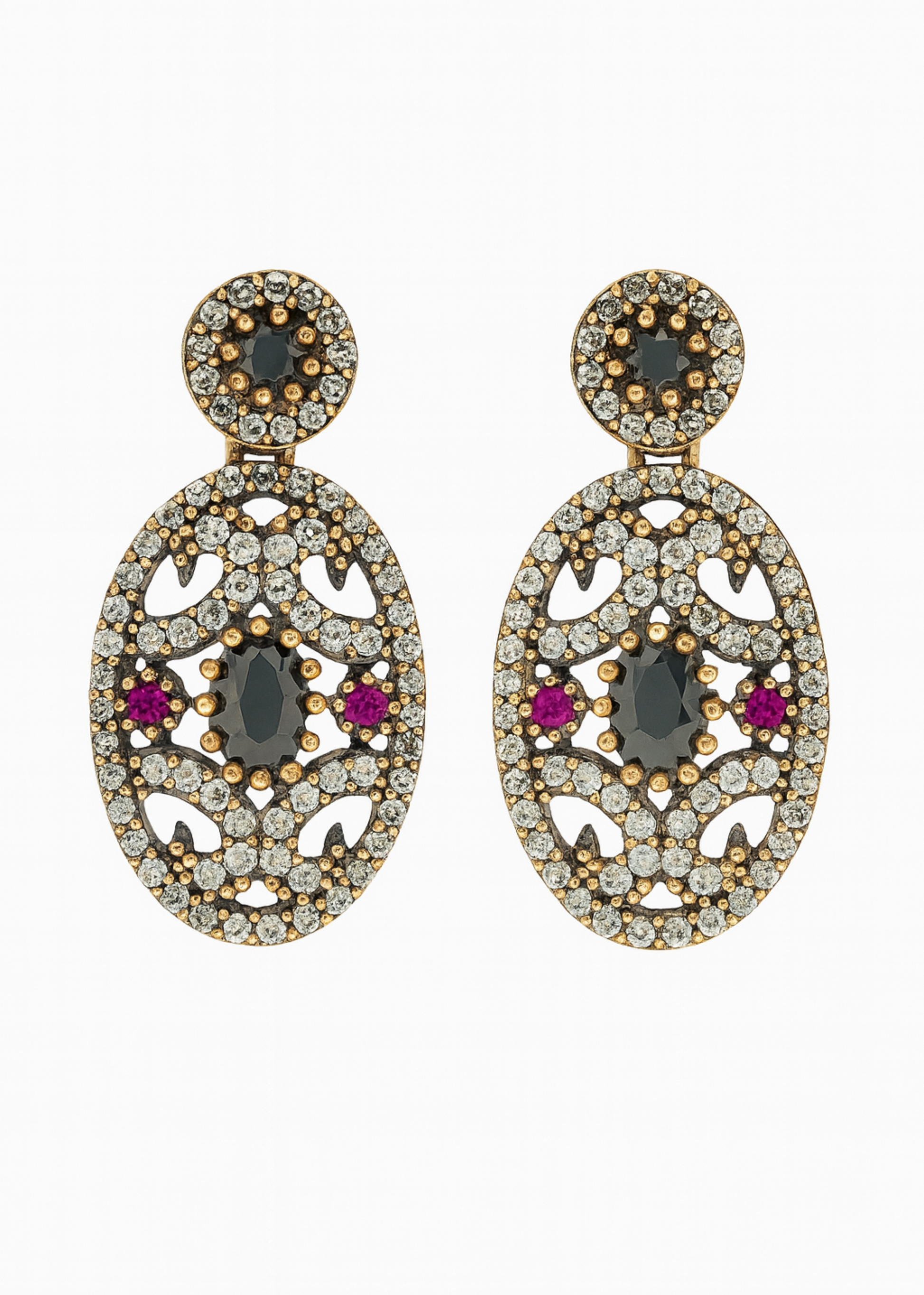 Pair of ornate earrings with gemstones on a white background