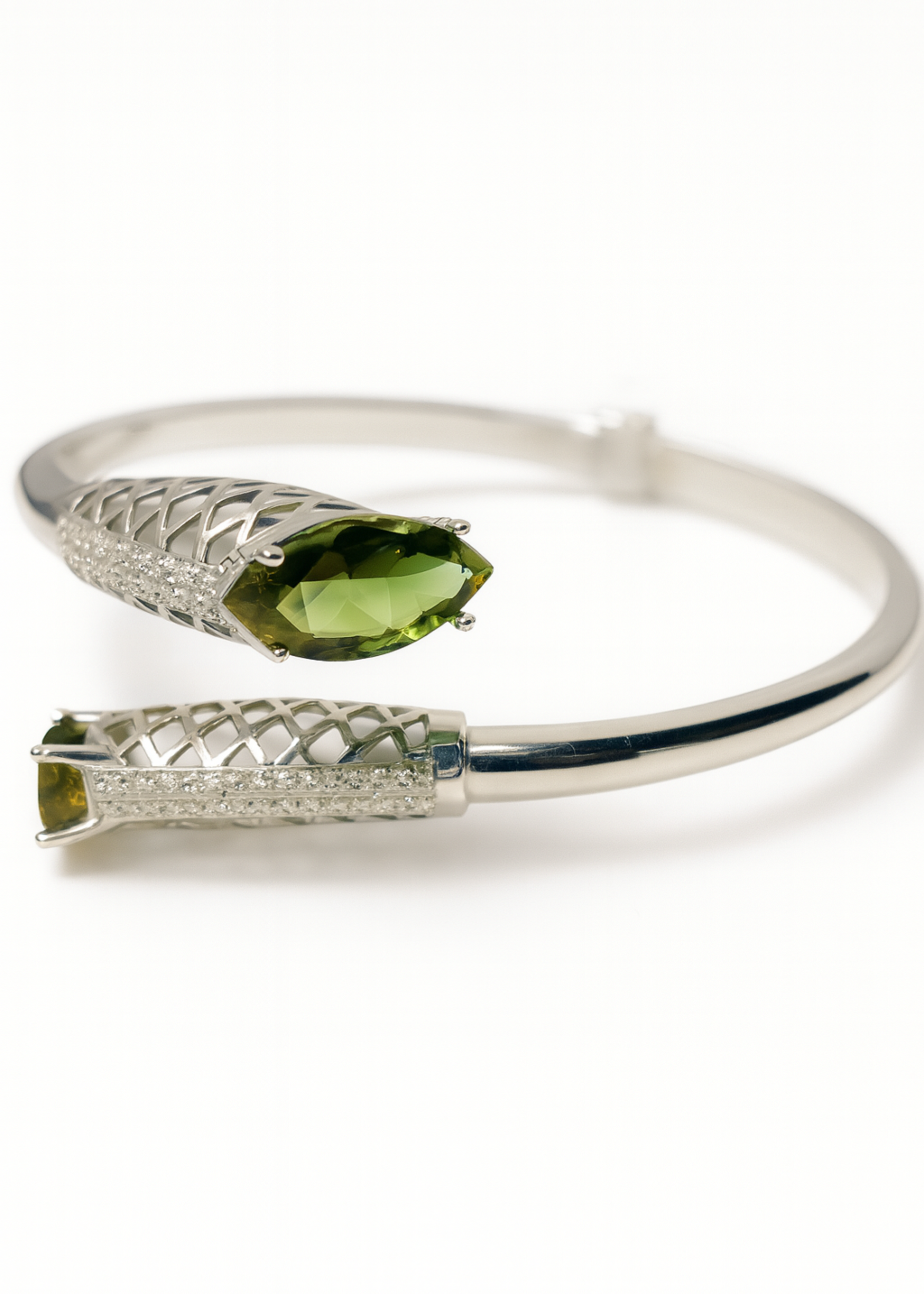 Silver bracelet with green gemstones on a white background