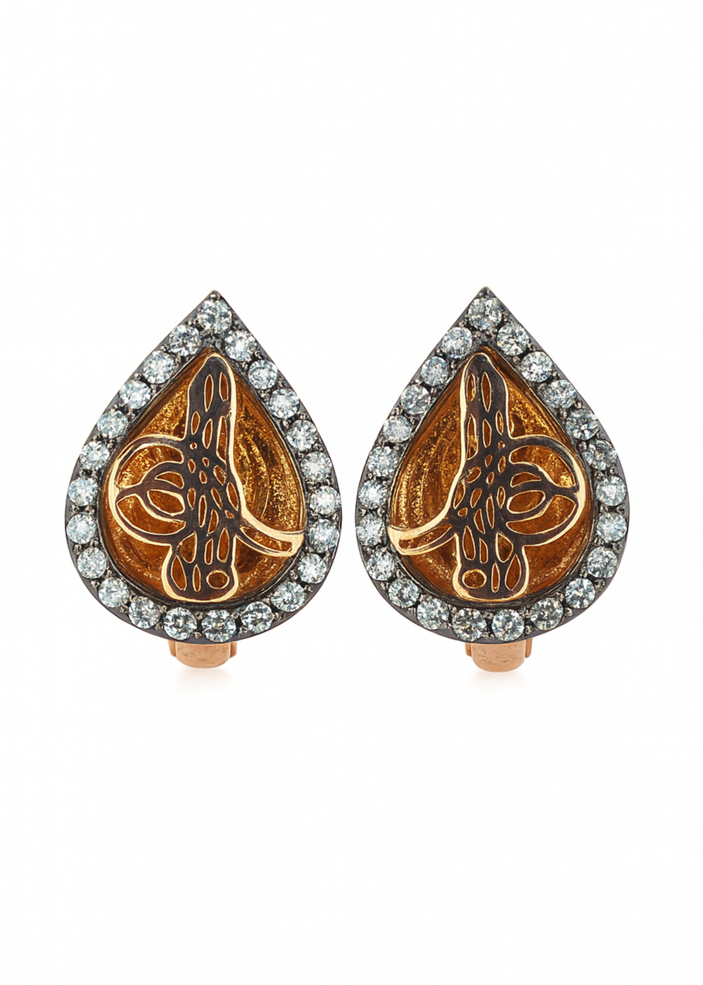 Pair of teardrop-shaped earrings with intricate designs and diamond accents on a white background