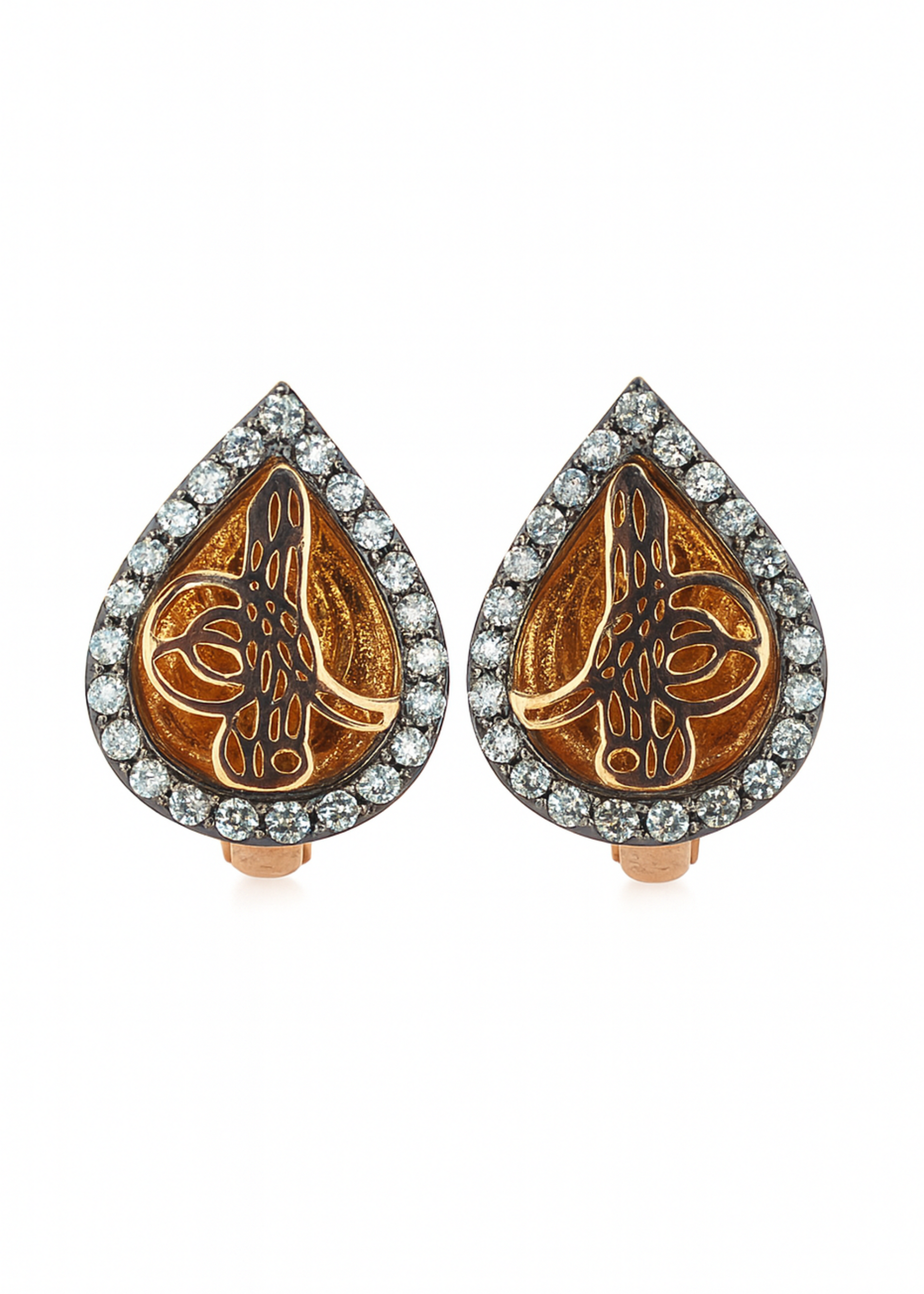 Pair of teardrop-shaped earrings with intricate designs and diamond accents on a white background