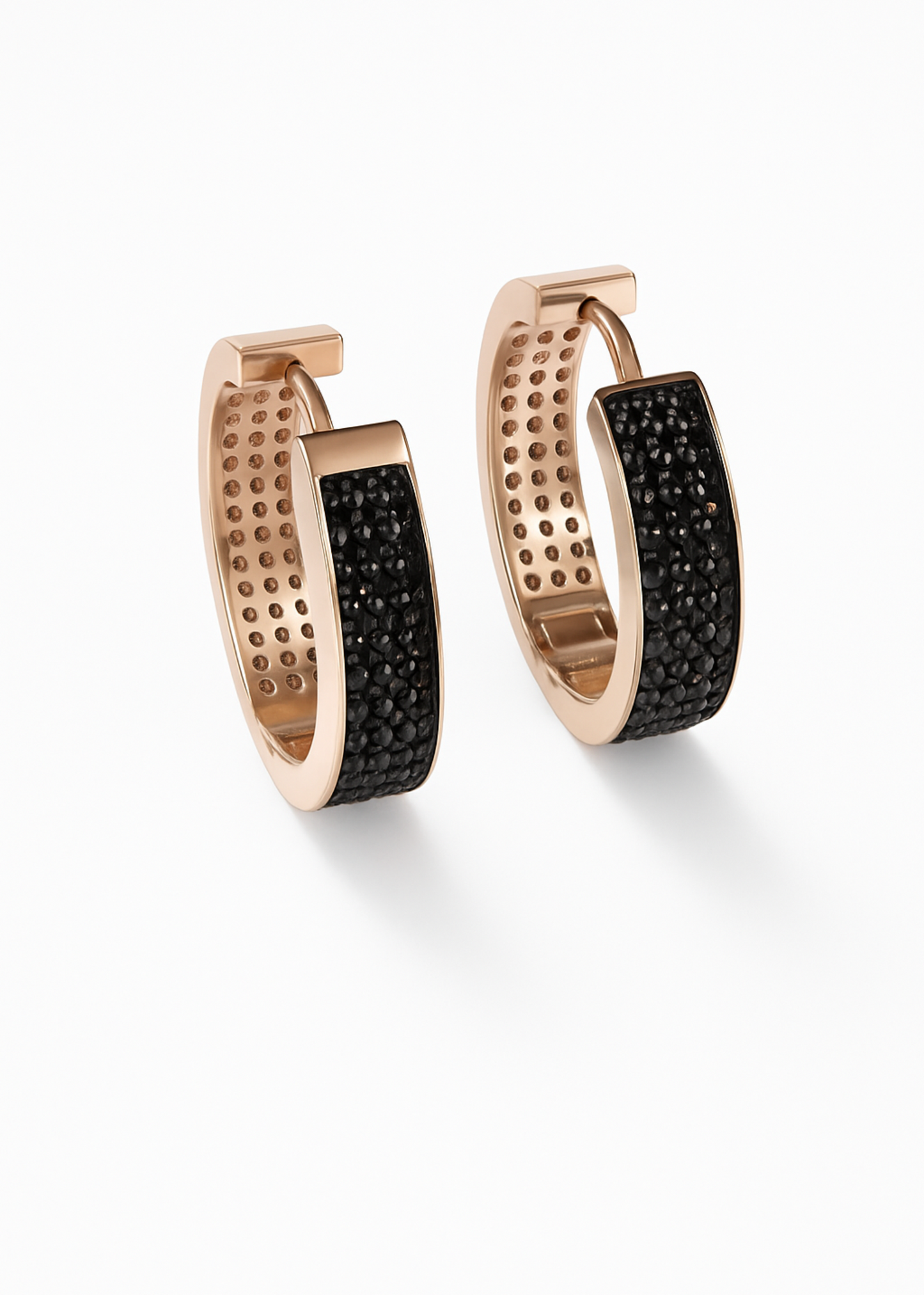 Pair of rose gold hoop earrings with black gemstones on a white background
