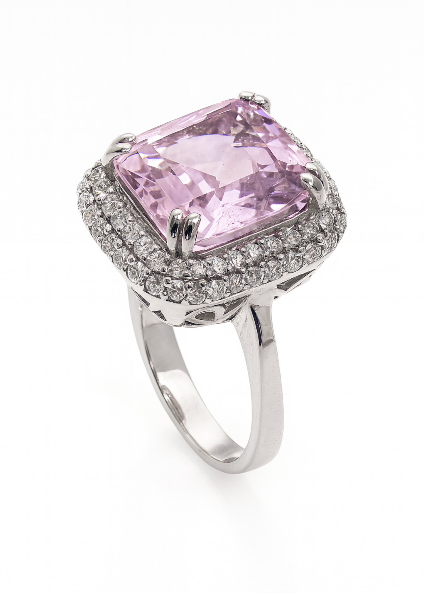 Ring with a pink gemstone and diamond-studded band on a white background