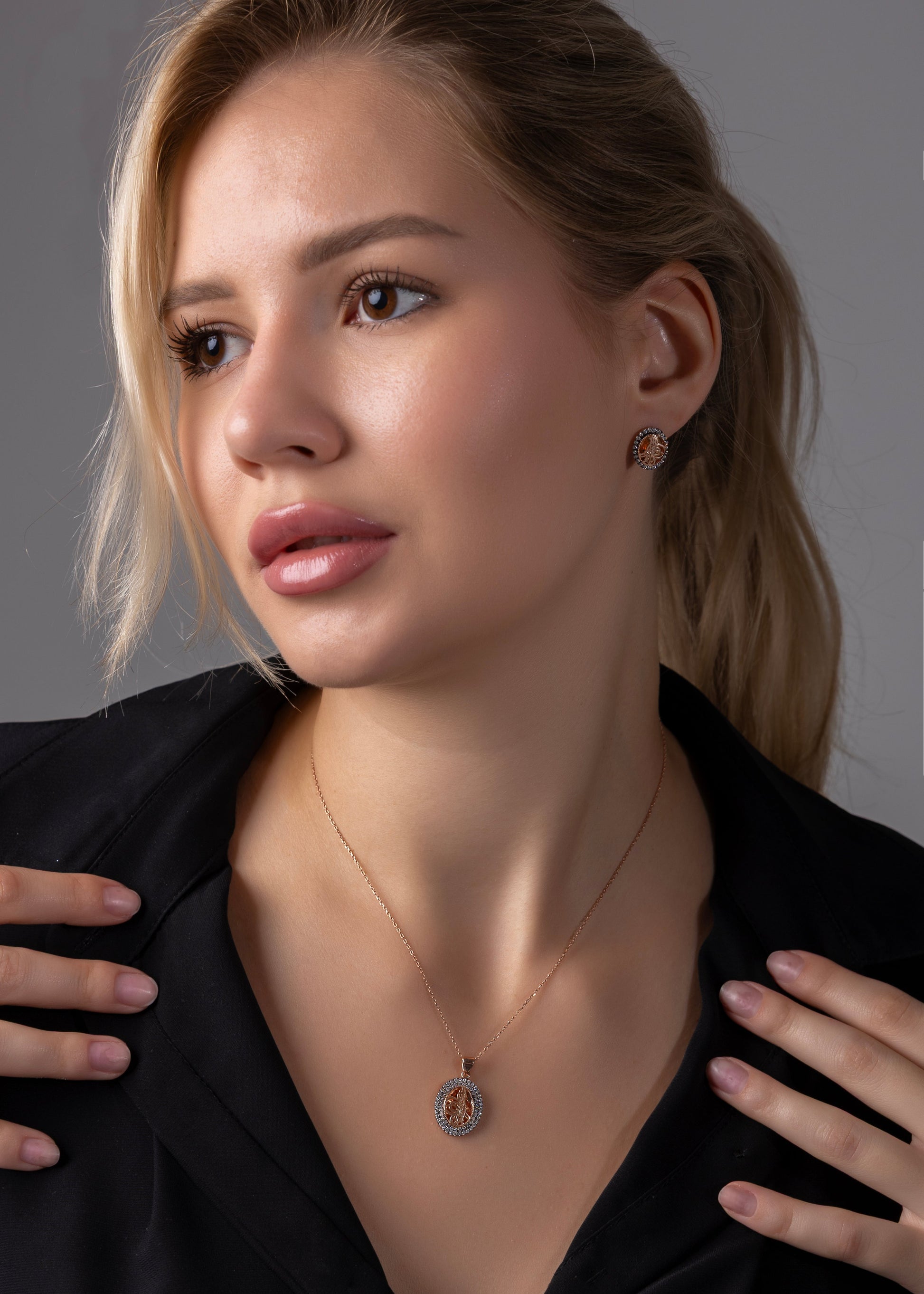 Woman wearing a necklace with a plain background
