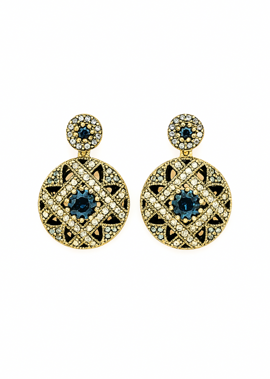 Pair of gold earrings with blue gemstones on a white background