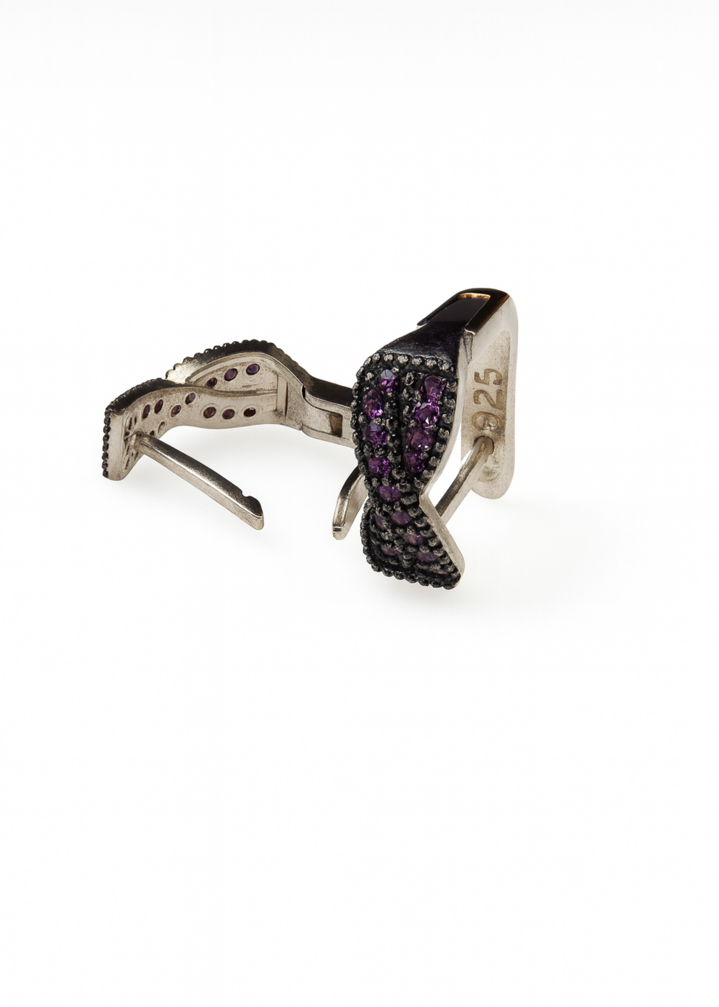 Silver ring with purple gemstones on a white background