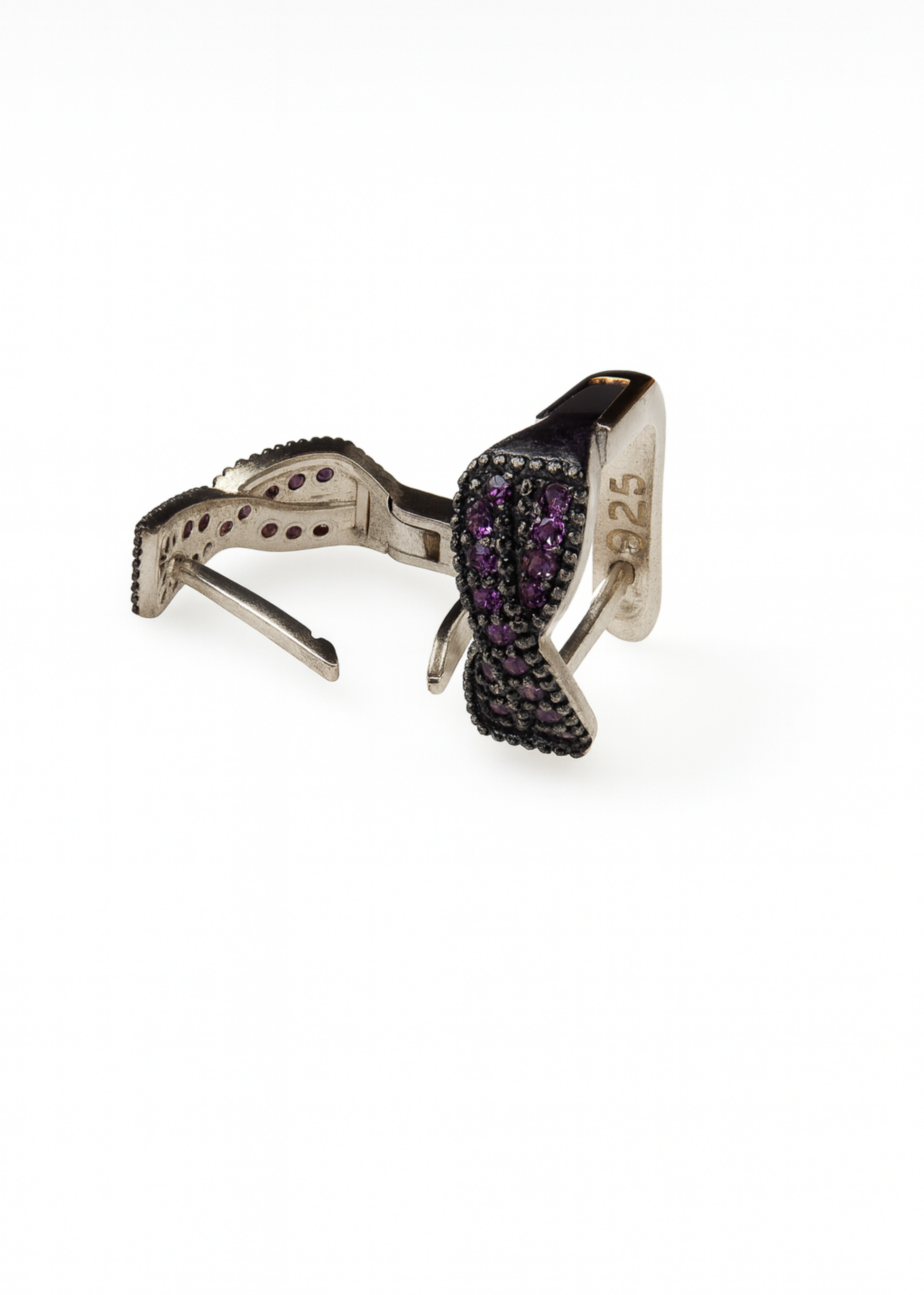 Silver ring with purple gemstones on a white background