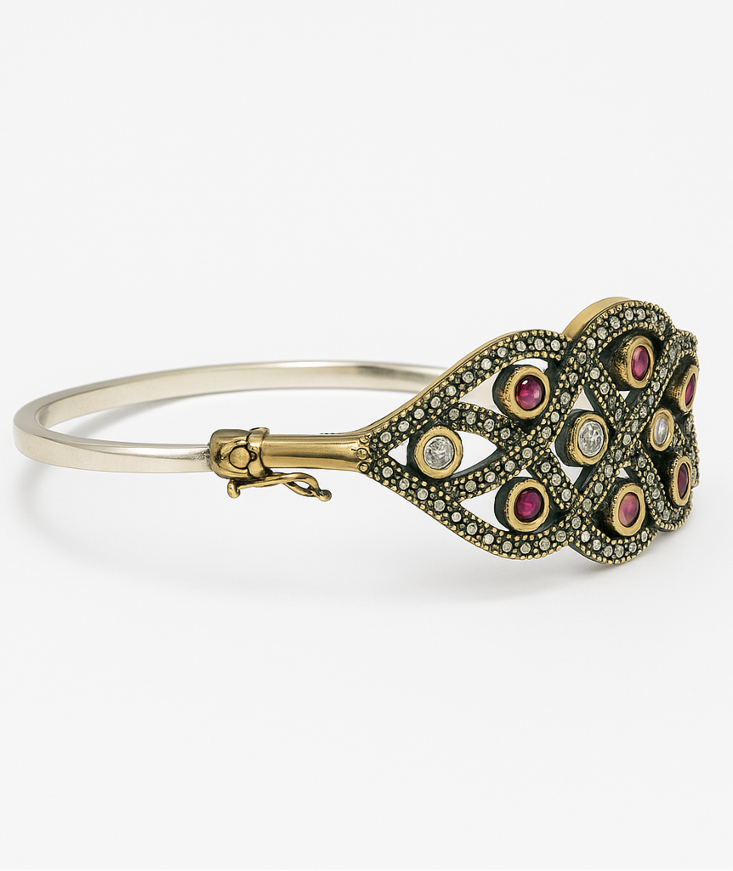 Gold and silver bracelet with gemstones on a white background