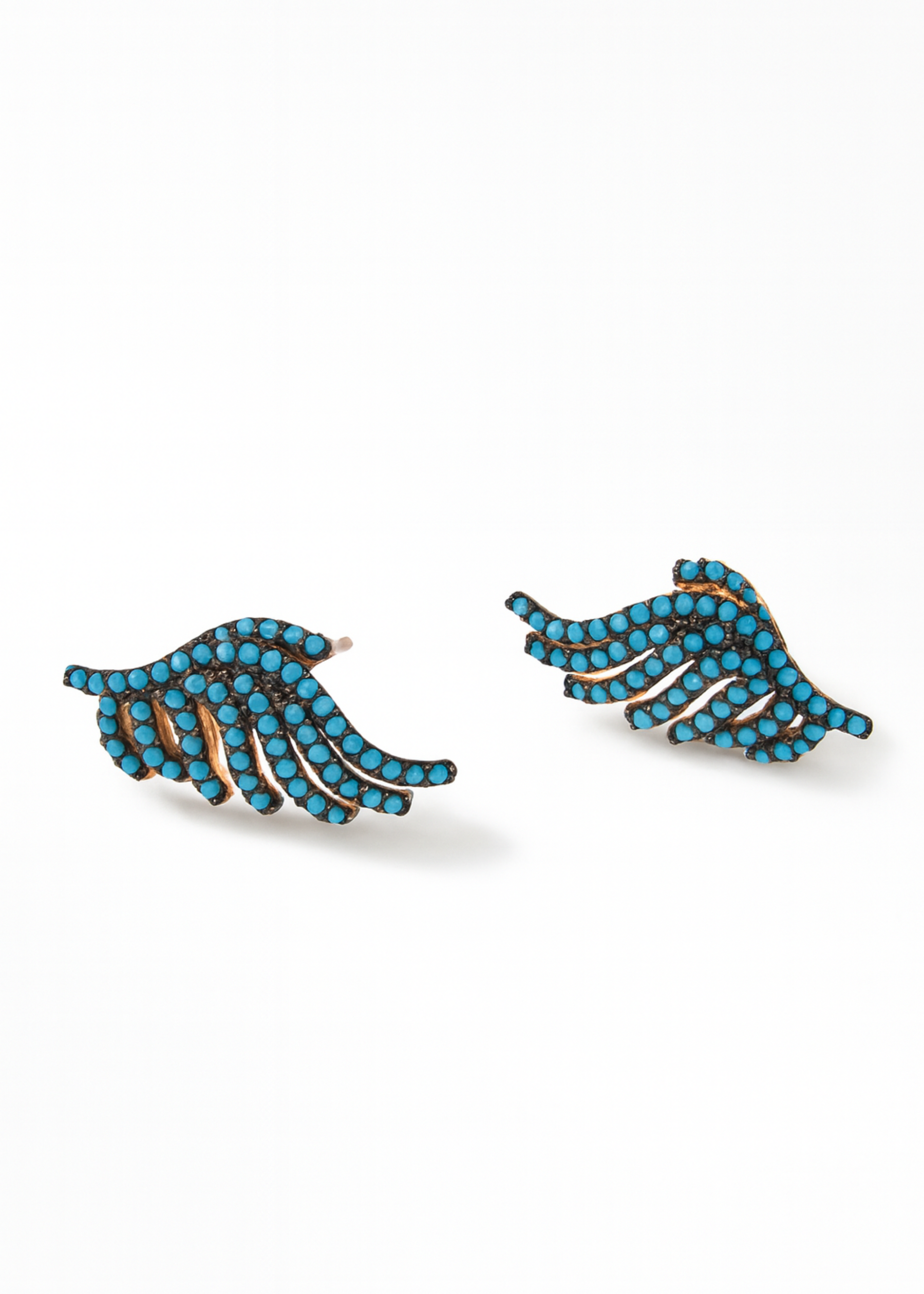 Pair of blue wing-shaped earrings on a white background