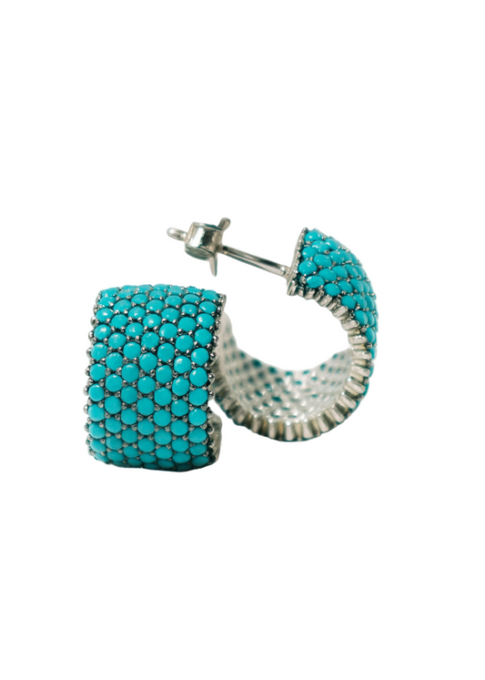Turquoise beaded hoop earrings on a white background