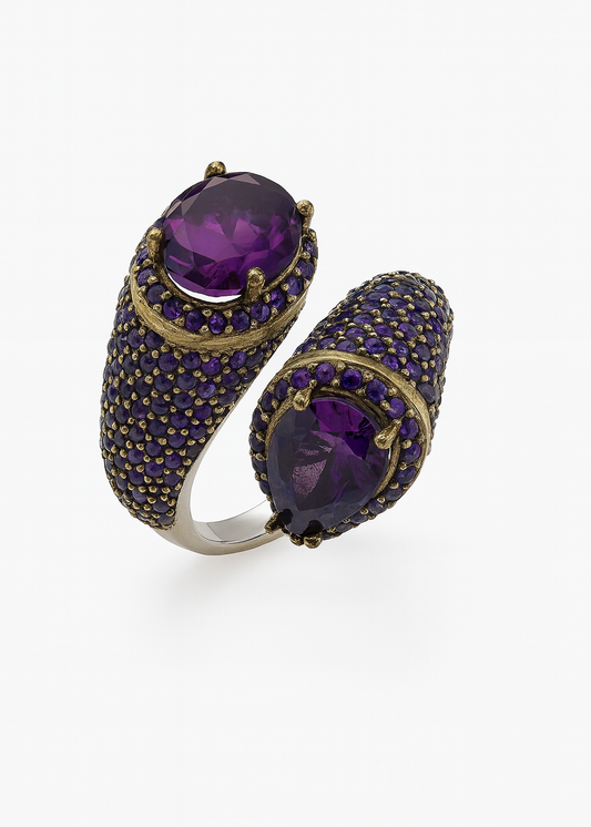 Gold and purple gemstone ring on a white background