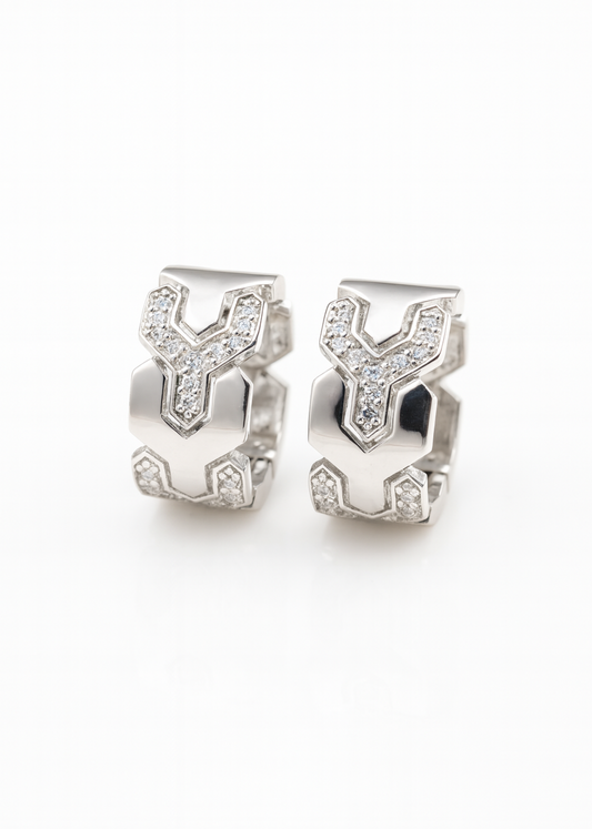 Pair of silver earrings with geometric design on a white background