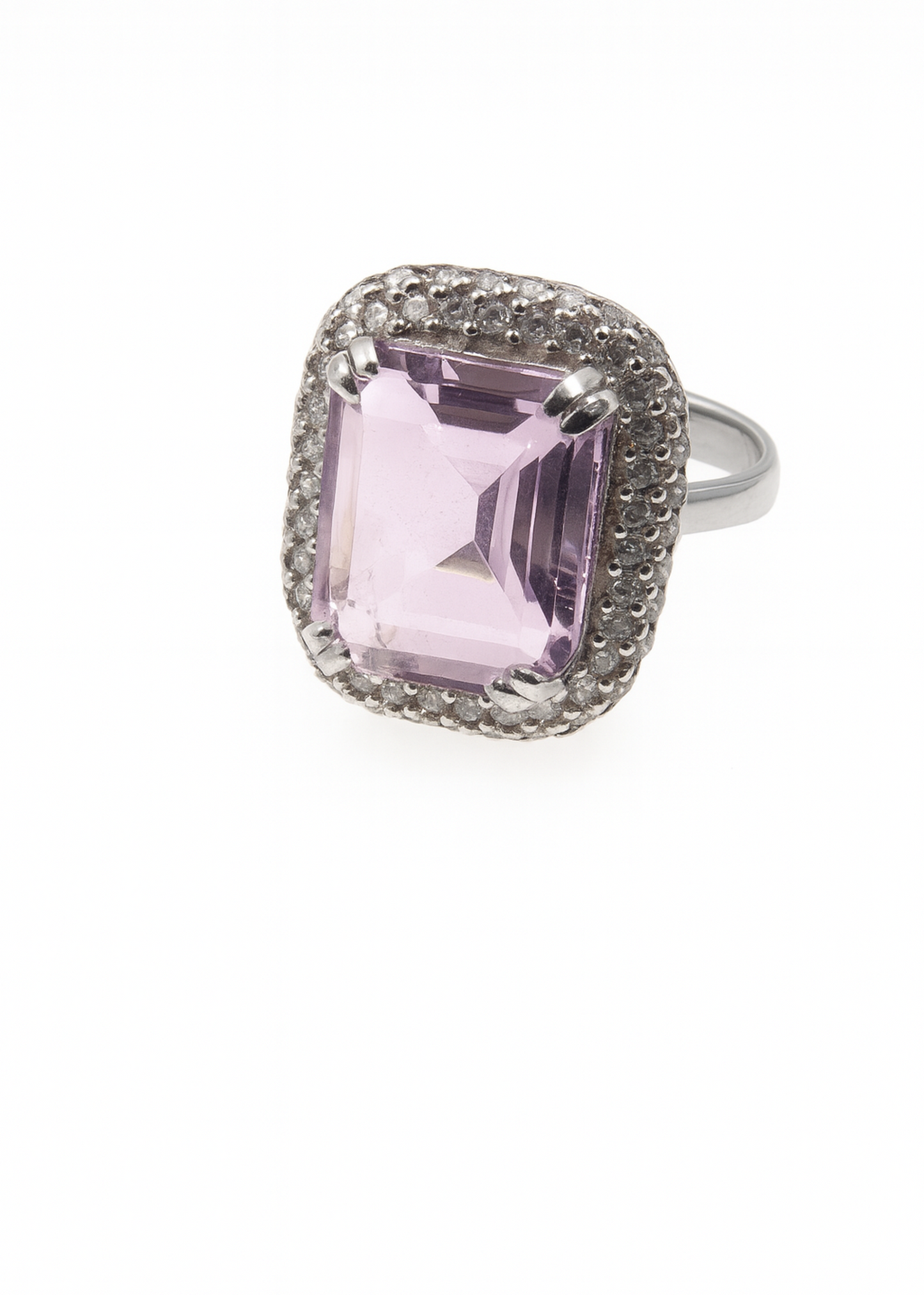 Ring with a pink gemstone and diamond-studded band on a white background