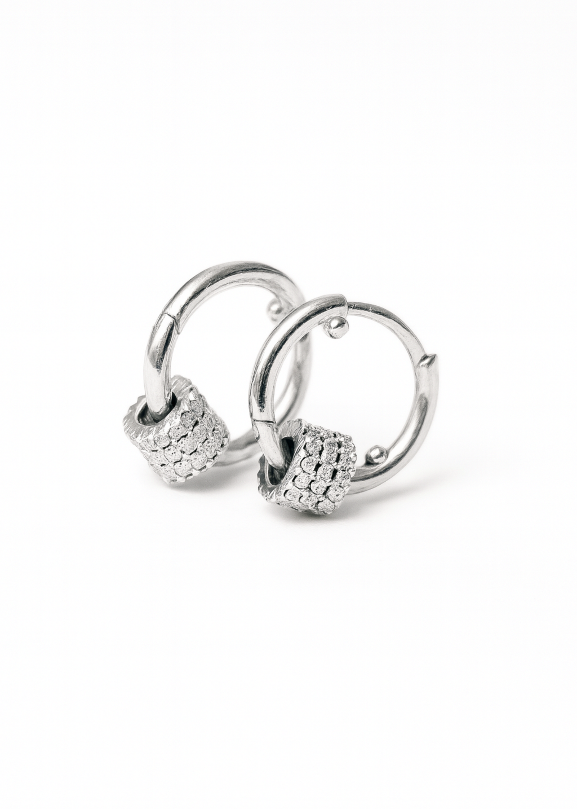 Silver hoop earrings with small round embellishments on a white background