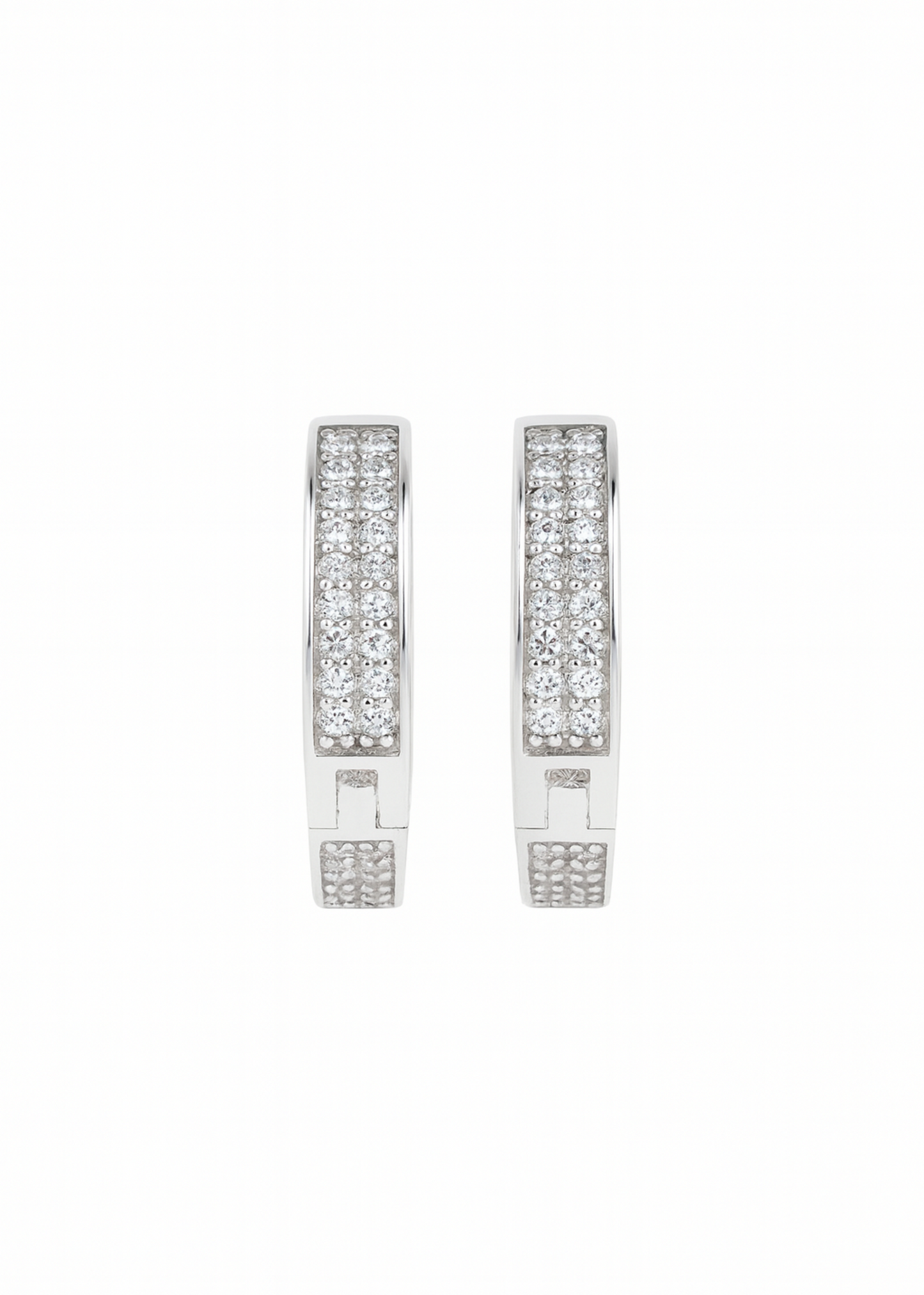 Pair of silver earrings with clear gemstones on a white background