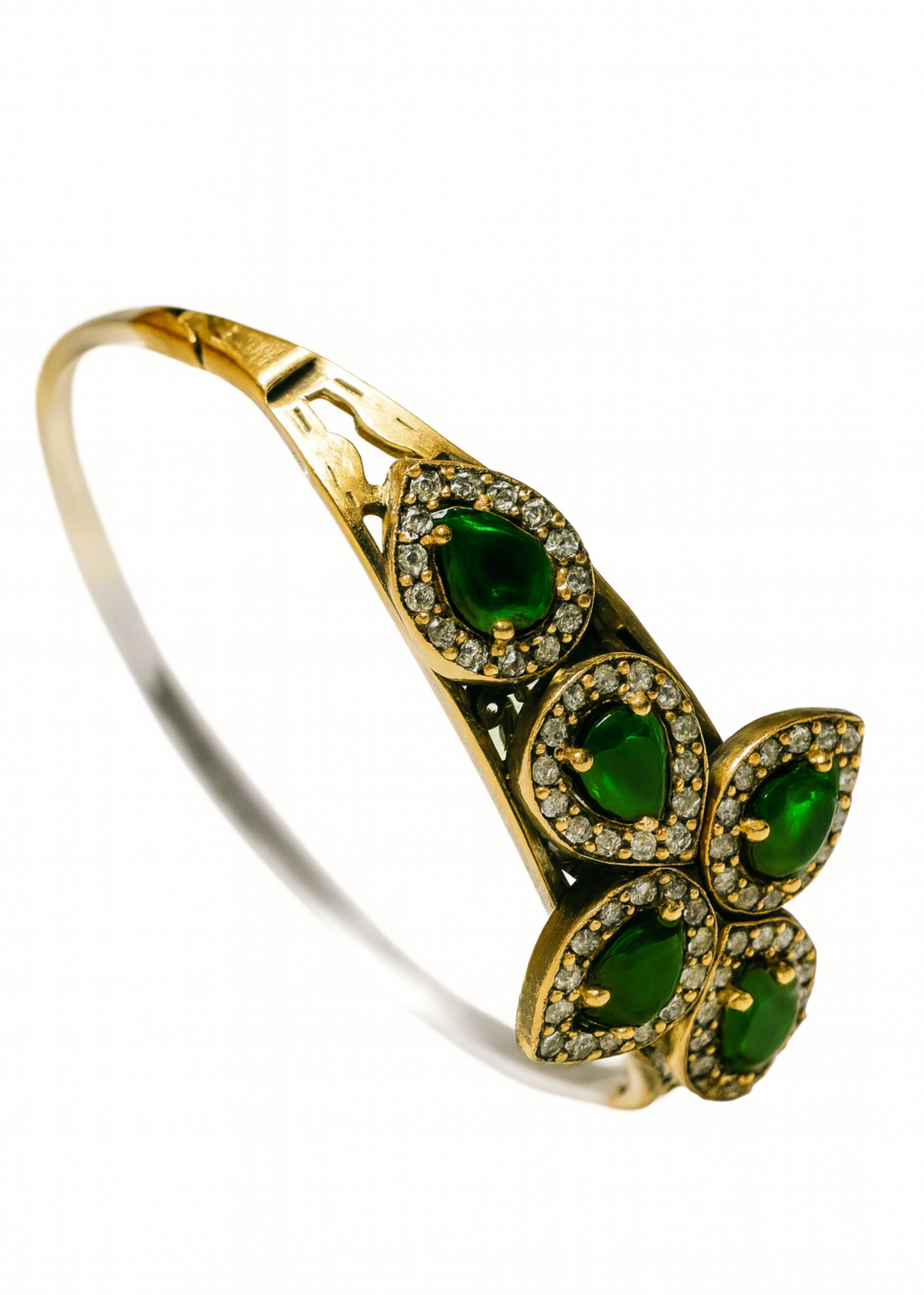 Gold bracelet with green gemstones on a white background