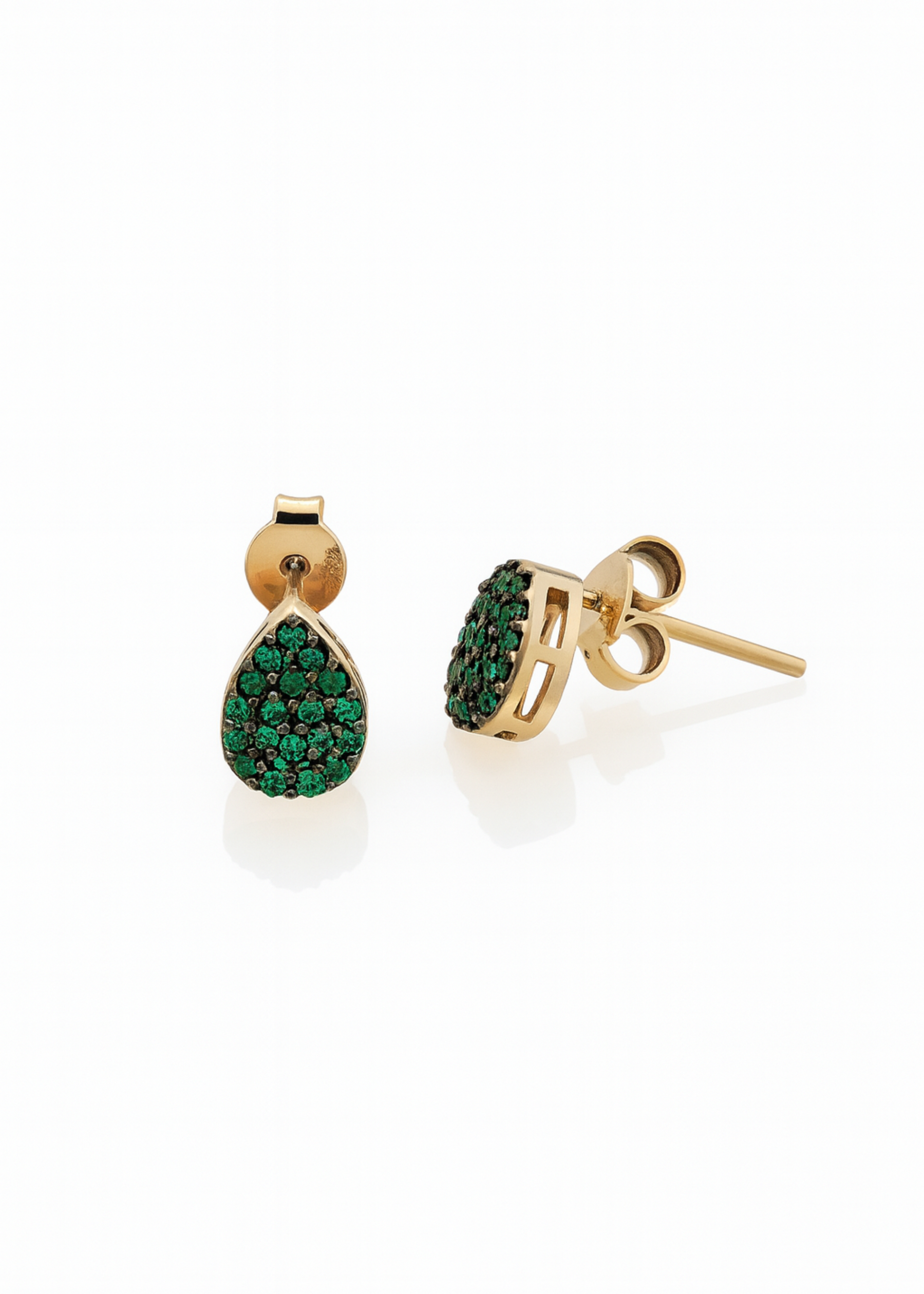 Gold earrings with green gemstones on a white background