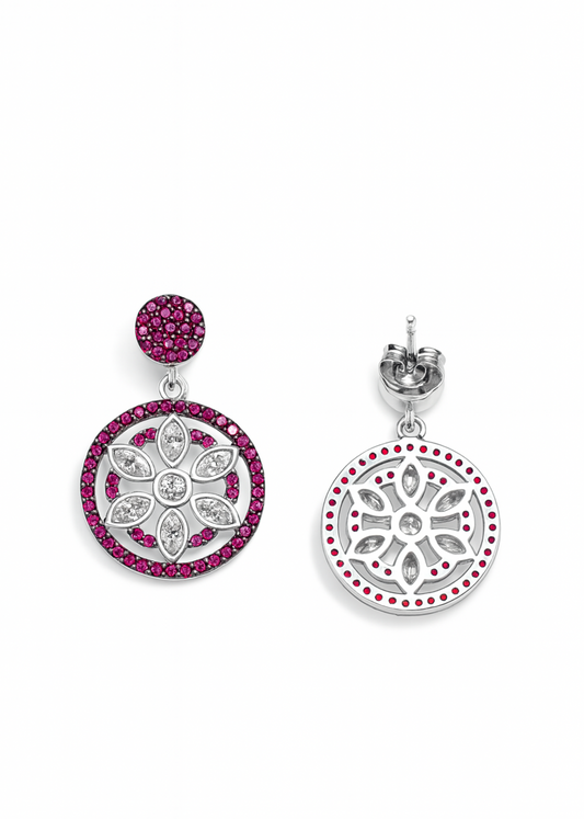 Pair of earrings with circular designs featuring pink gemstones on a white background