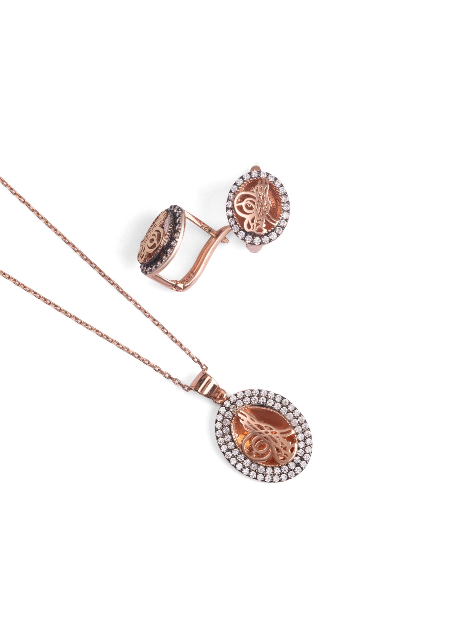 Rose gold necklace with circular pendant on a white background