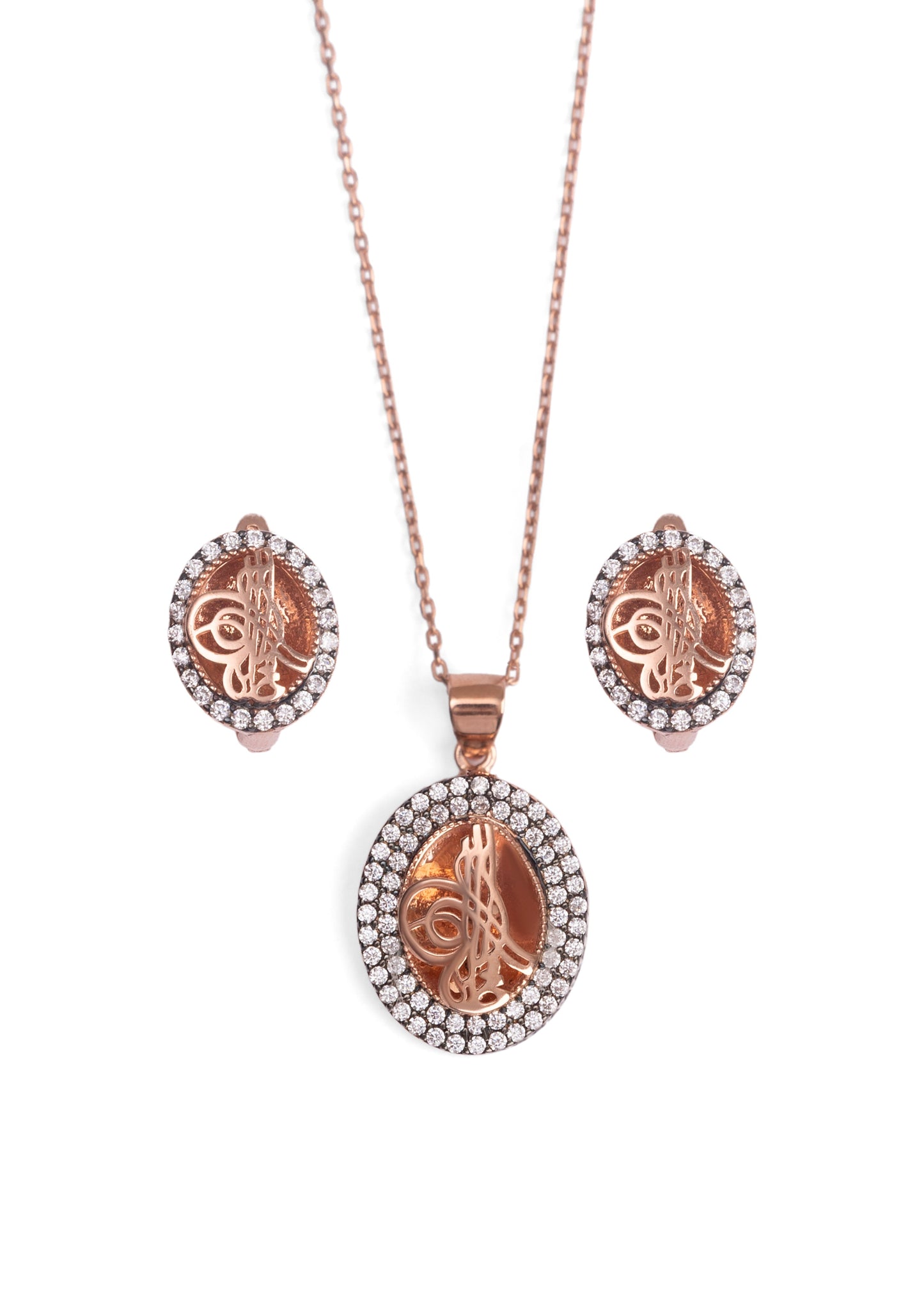 Rose gold necklace and earrings set on a white background