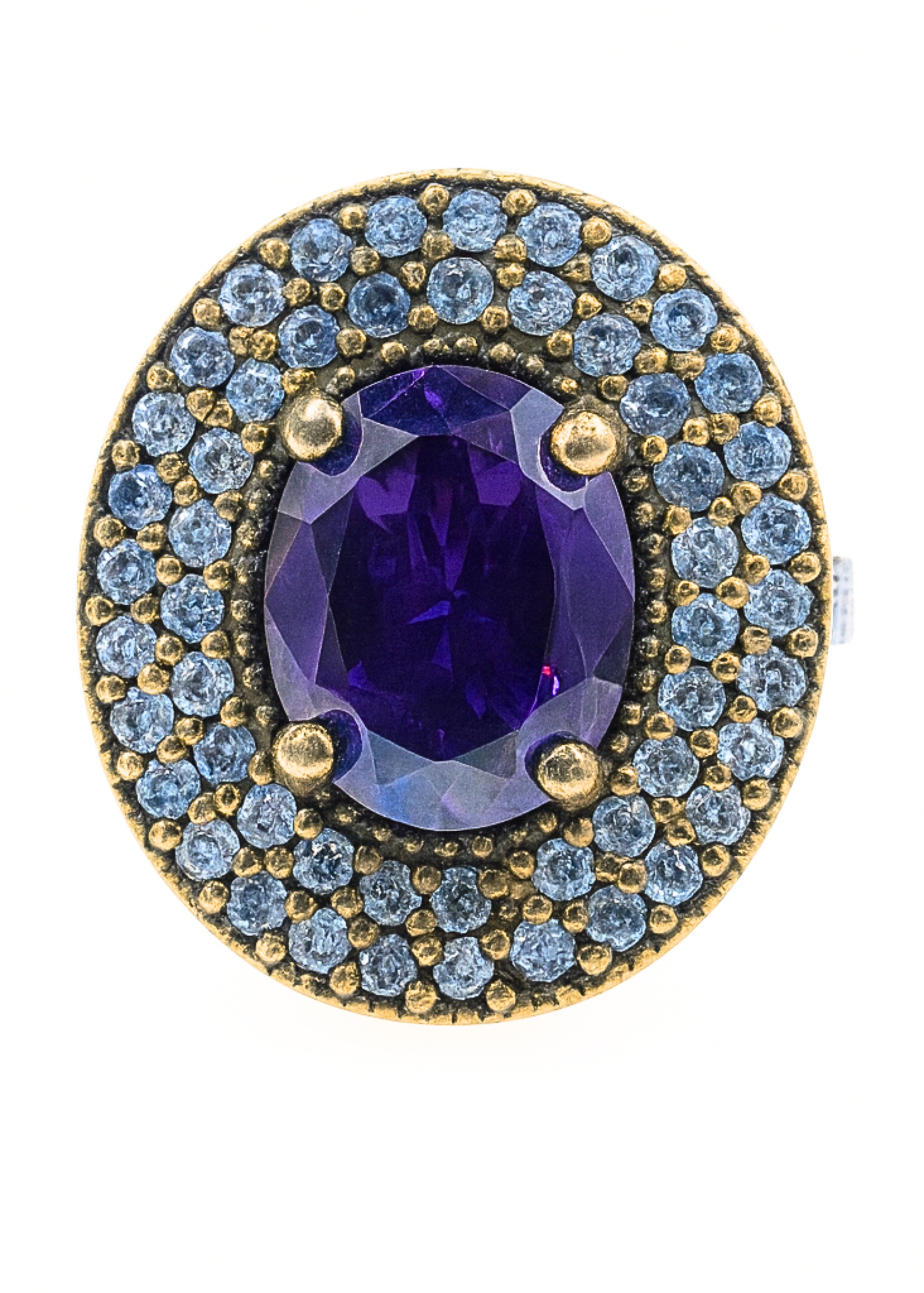 Jewelry ring with purple gemstone and blue gemstones on a white background