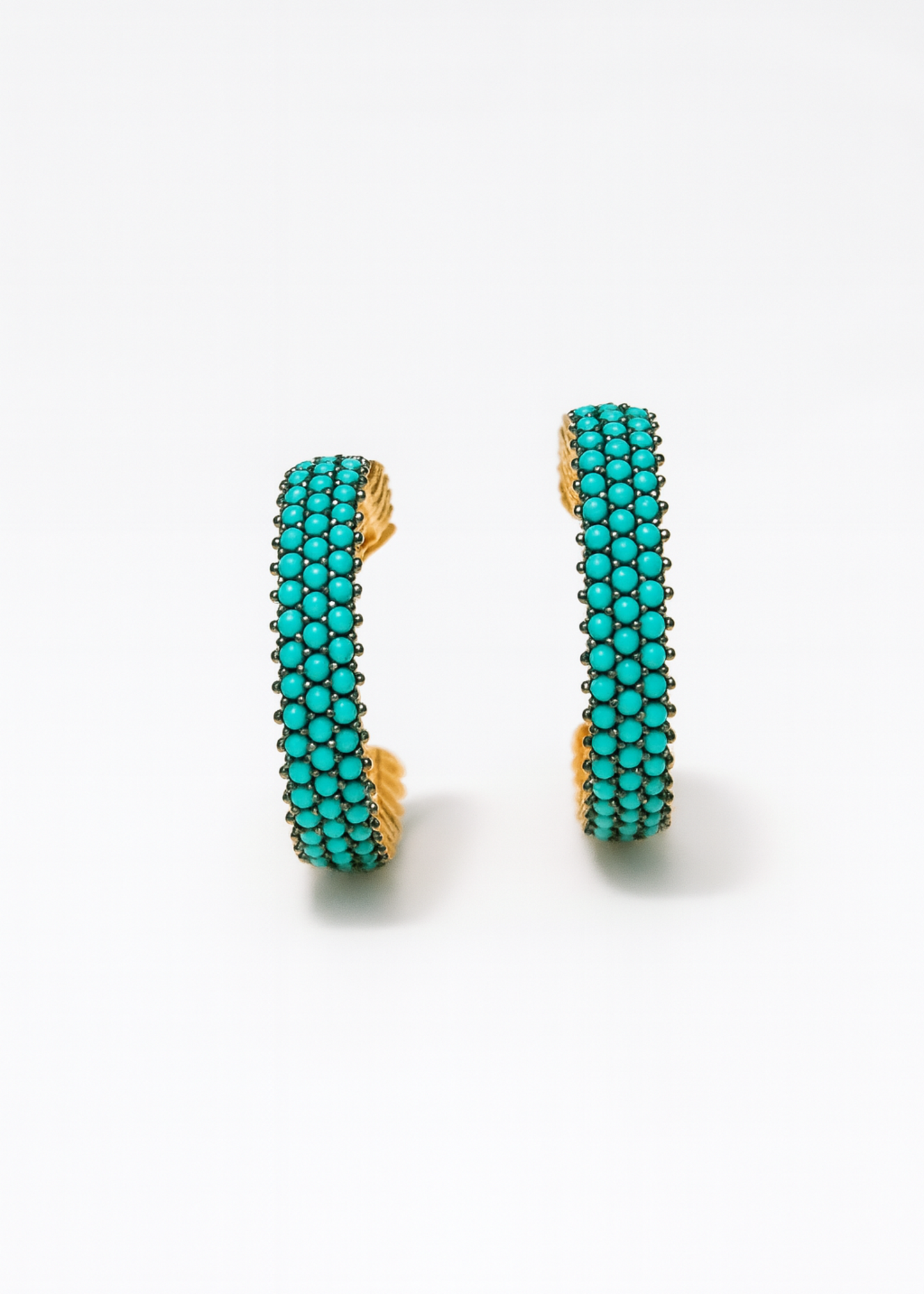Turquoise hoop earrings on a white background