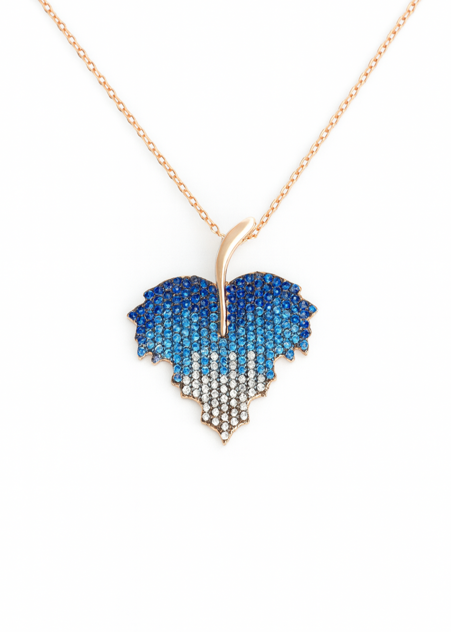 Heart-shaped pendant with blue and white gradient on a gold chain against a white background