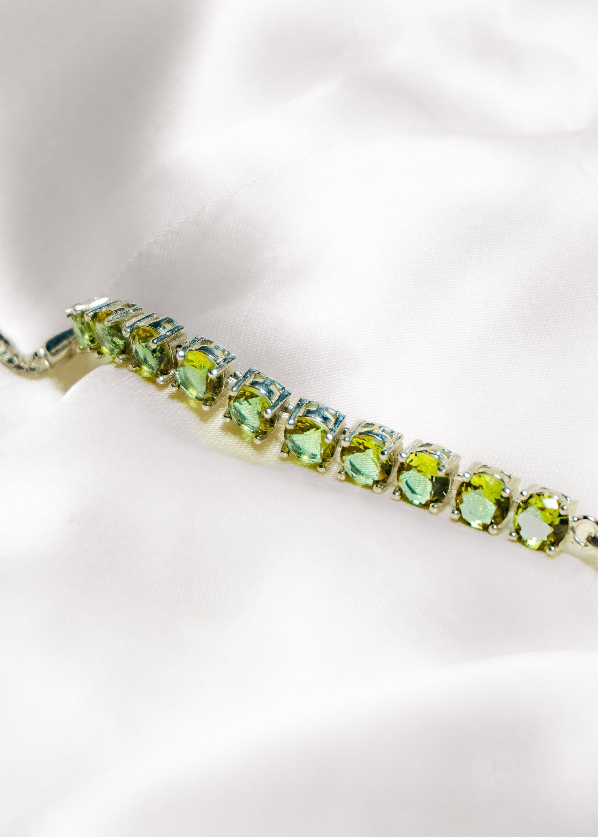Green gemstone bracelet on a white background